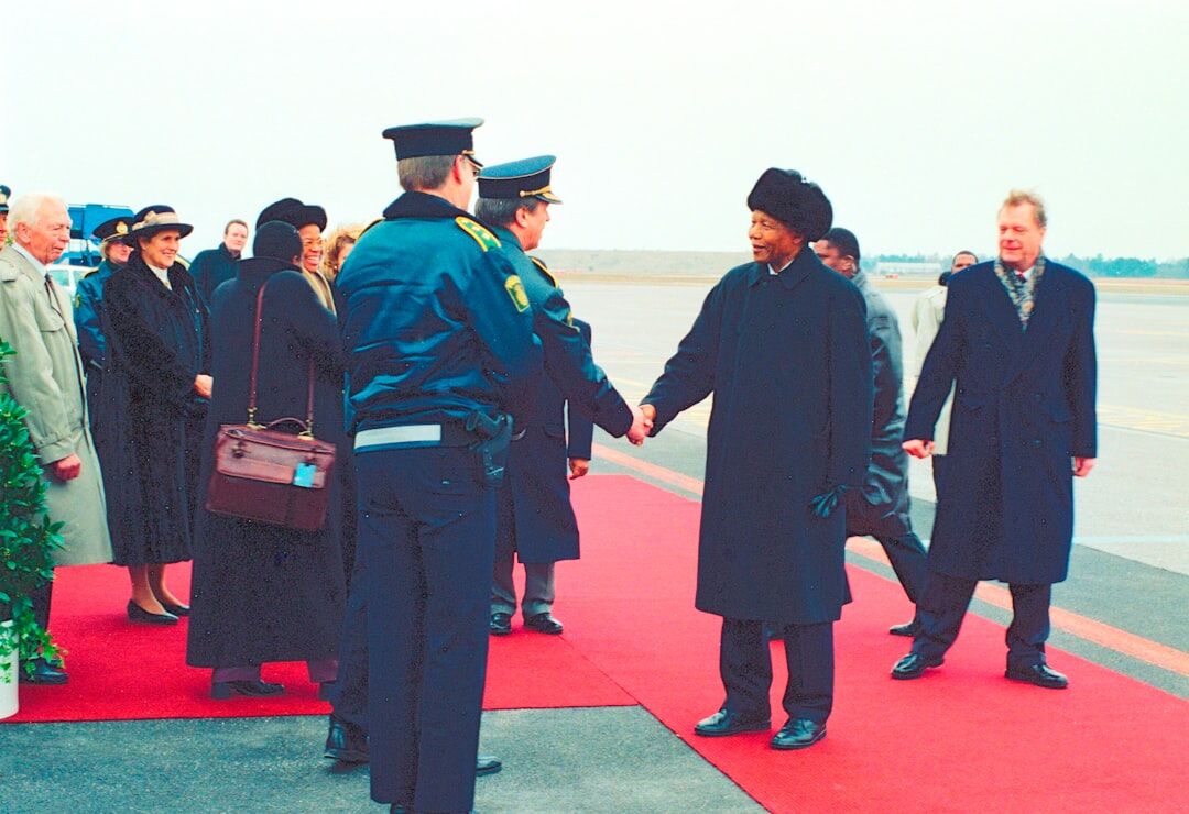 Celebrity walking on a red carpet under flashing camera lights